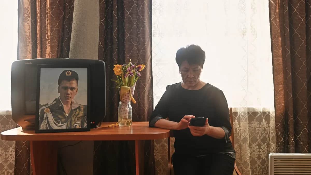 Nurzia and the portrait of her youngest son Rishat. Photo: Yevgeny Kulikov