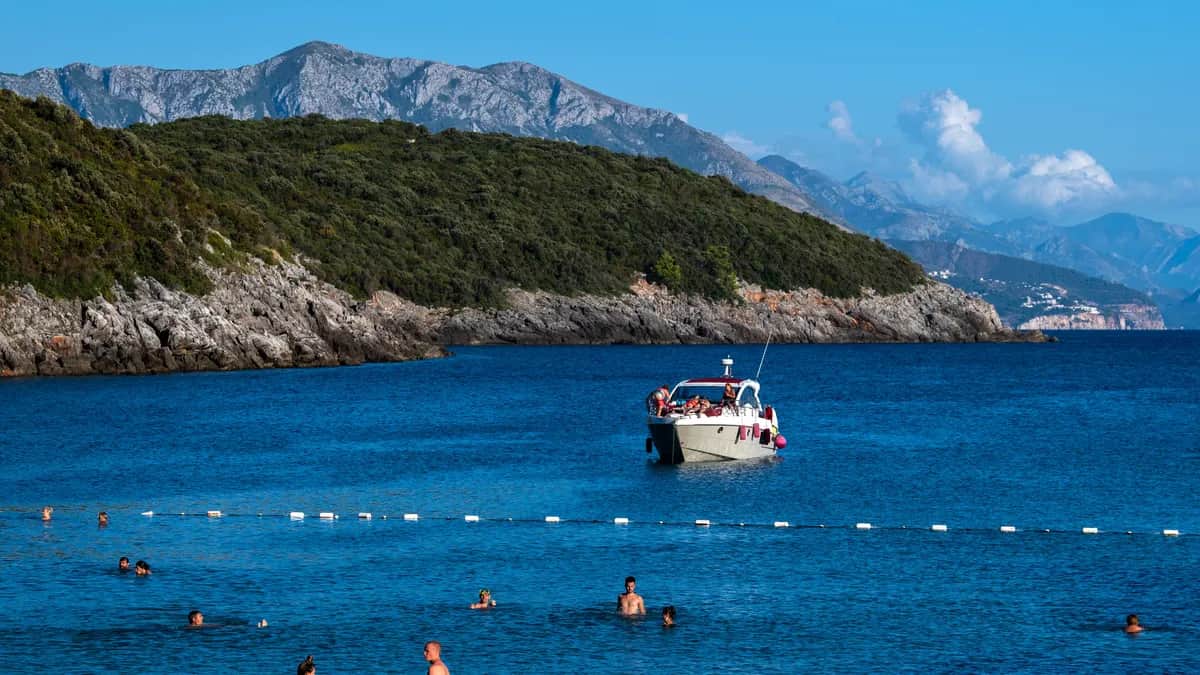 Beachgoers enjoy the sun near Budva, Montenegro, on 11 September 2022. Photo: EPA-EFE/GEORGI LICOVSKI