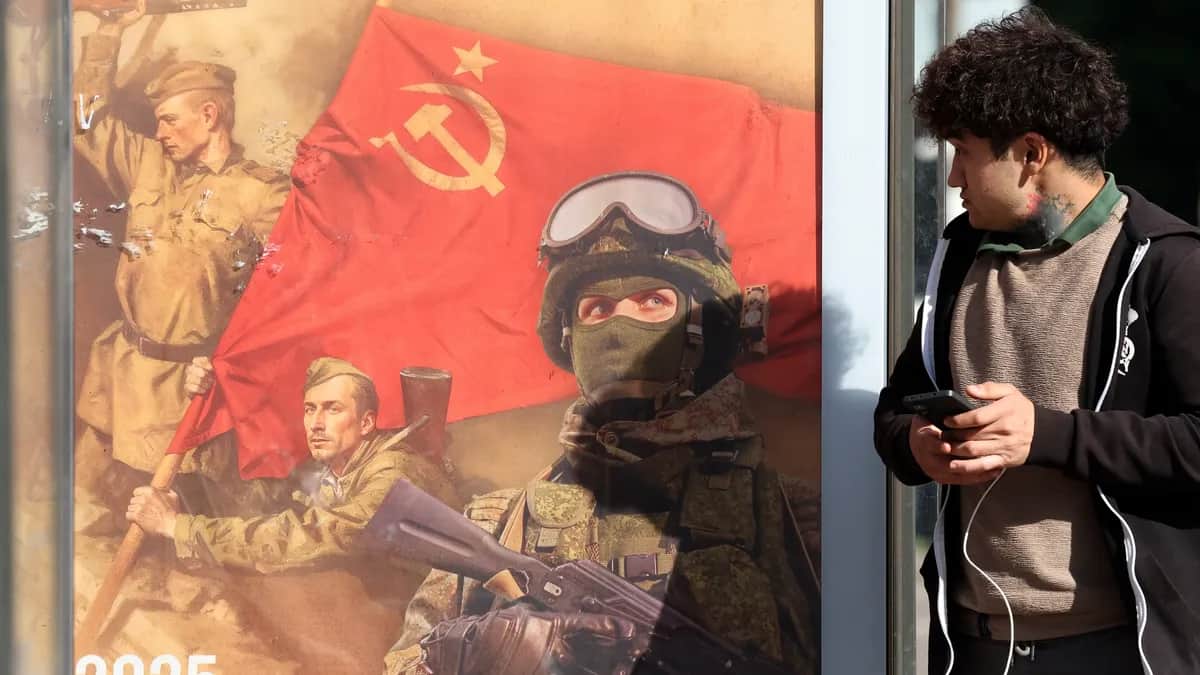 A man walks past a poster featuring Soviet and Russian soldiers in Podolsk, outside Moscow, Russia, 21 May 2025. EPA/MAXIM SHIPENKOV