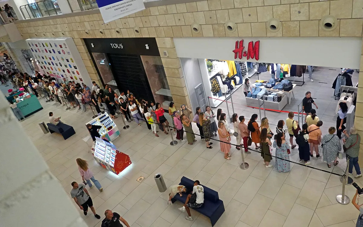 Russian people stand in line to enter H&amp;M store in the Metropolis shopping mall in Moscow, Russia, 03 August 2022. Photo by EPA-EFE/MAXIM SHIPENKOV
